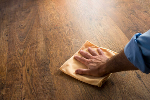 A person cleaning wooden floors.