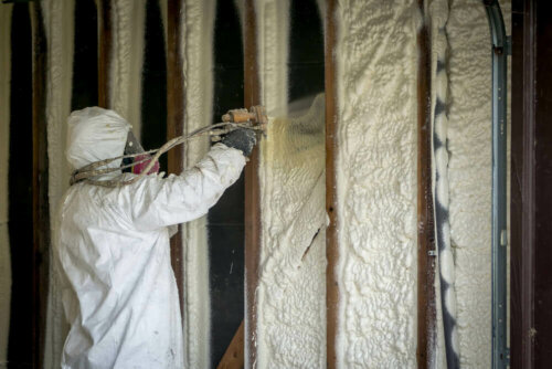 A person insulating a home.