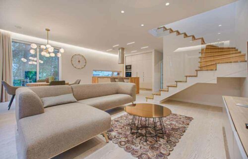 Large tan sectional couch in a large living room