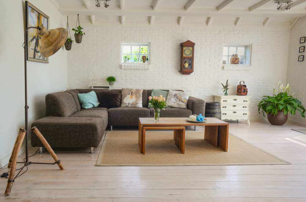 White room with a gray sectional.