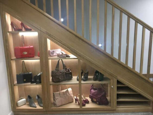 A shoe rack under the stairs.
