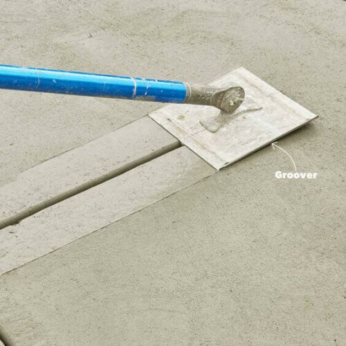 A person smoothing a concrete platform.