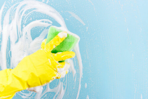 A person cleaning with a sponge.