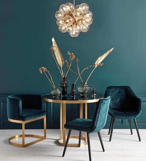 A dining room with some gold accents.