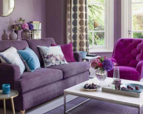 A living room with some flowers on the coffee table.