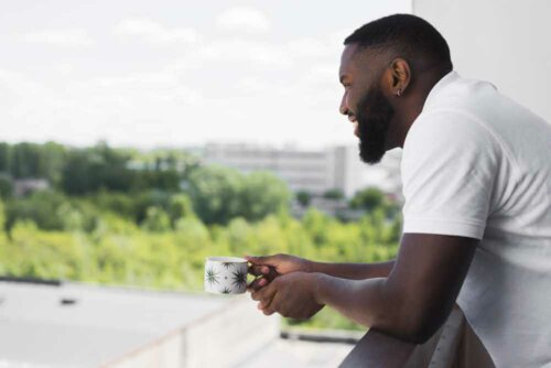 A man enjoying a good view from his balcony.