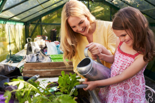 A mother and child watering their plants.