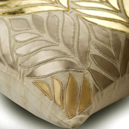 A pillow with some golden engravings.