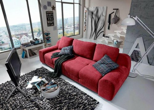 A sofa in a cluttered living room.