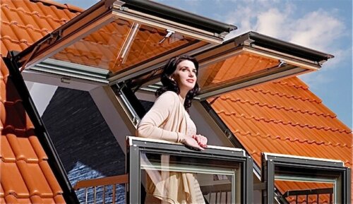 A woman looking out from her balcony.