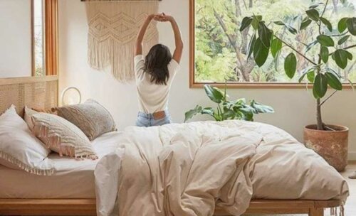 A woman stretching on her bed.