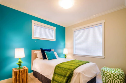 A blue-green wall in a bedroom.