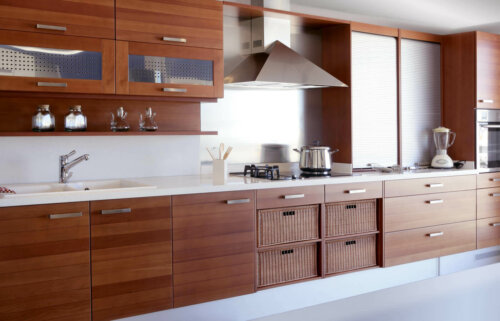 A kitchen with all wooden kitchen cabinets