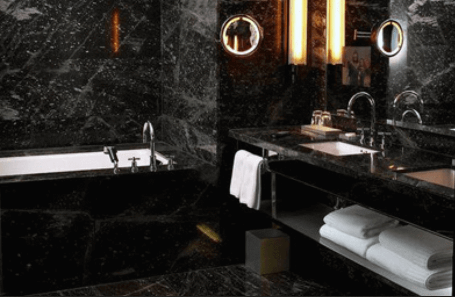 black marble bathroom with white towels