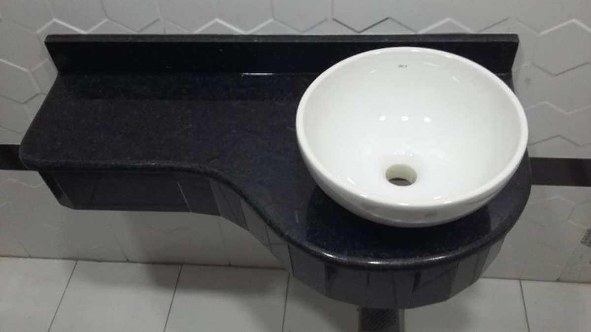 A sink that has a black marble part
