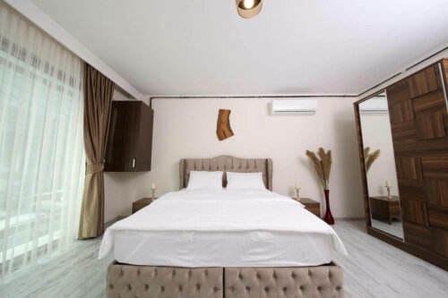 A bedroom with some cooling devices.