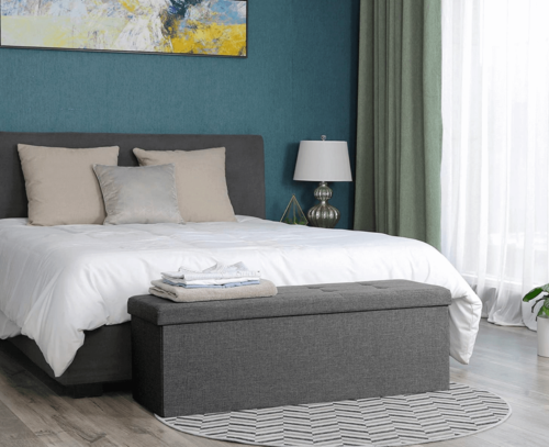 A minimalist chest at the foot of the bed.