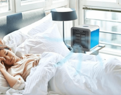 A woman with an air conditioner in the bedroom.