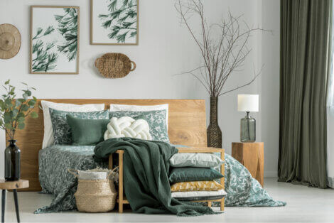 A bedroom decorated in green and natural wood