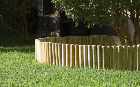 Yard border around a tree composed of posts.