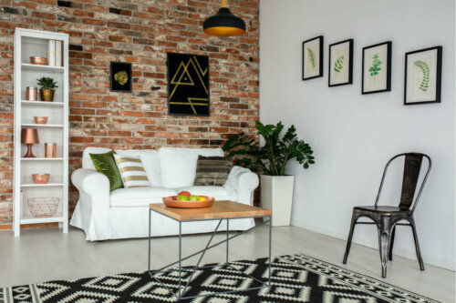 A living room with a brick wall which helps you have the industrial style in your home.
