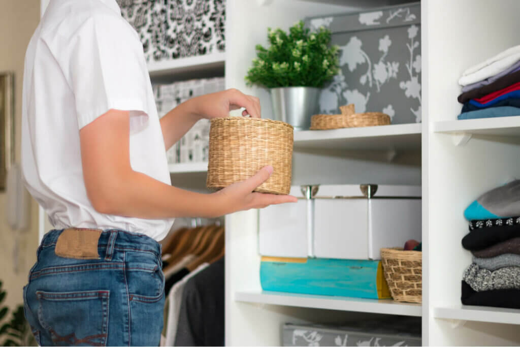 A person tidying up their living room.