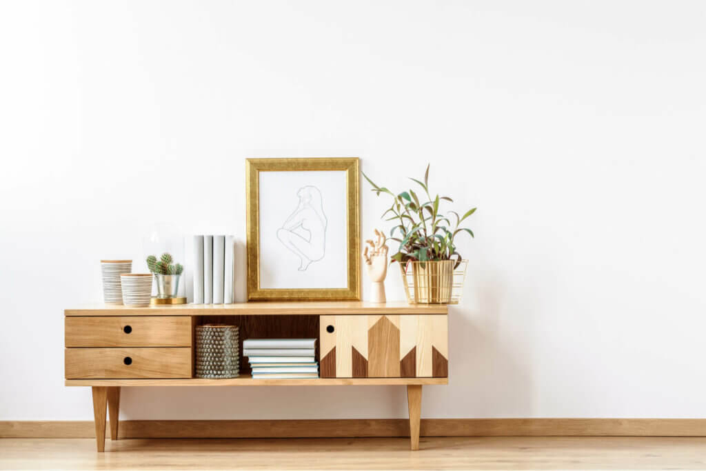 A wood sideboard with mirror.