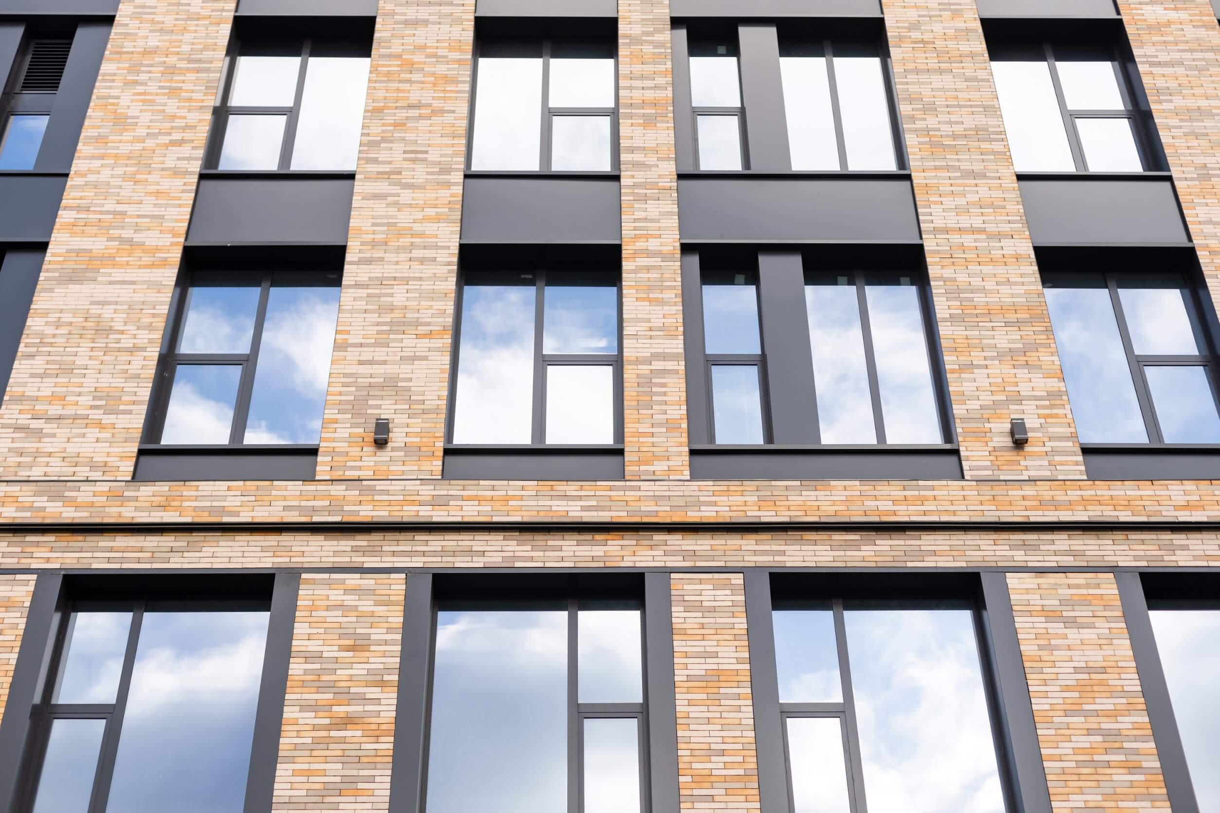 A brick building with aluminum windows.