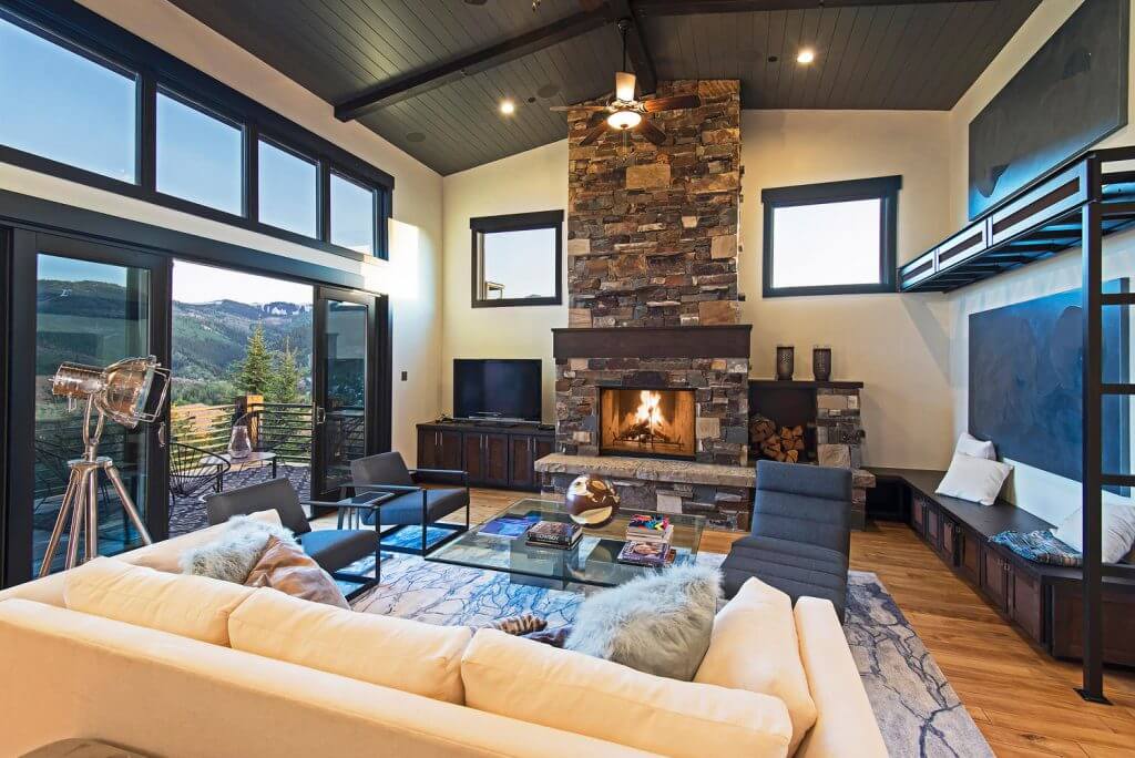 A living room decorated in City Park style overlooking the mountains.